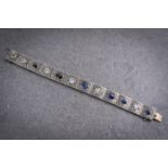 An antique platinum and sapphire articulated bracelet, designed as a series of ornately carved,