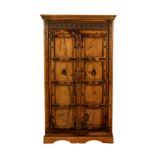 A carved and panelled iron-bound walnut two-door strong cupboard, probably Spanish, 19th century