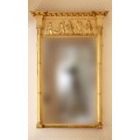 A Regency giltwood pier mirror, the ball decorated flared top with outset corners on cluster