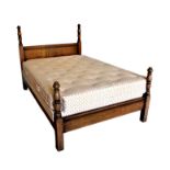 A carved oak double bed, 20th century, with turned uprights, 54in. (137cm.) wide, 84in. (213cm.)