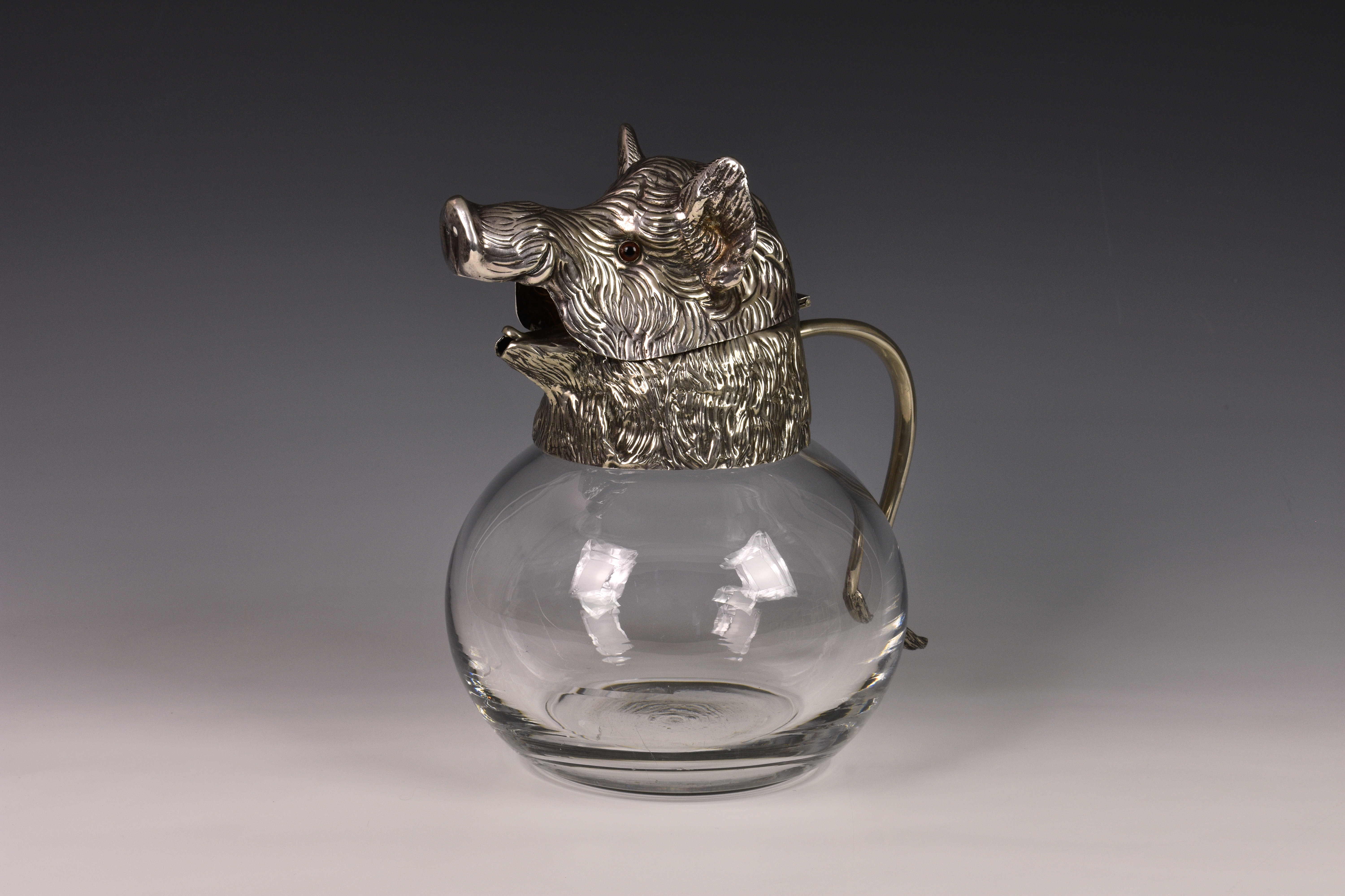 A novelty Continental silver plate glass carafe mounted with a wild boar's head, 1960s, the clear