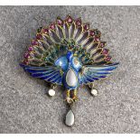 An Art Nouveau silver gilt, plique-à-jour, mother-of-pearl and gem set peacock pendant, first half