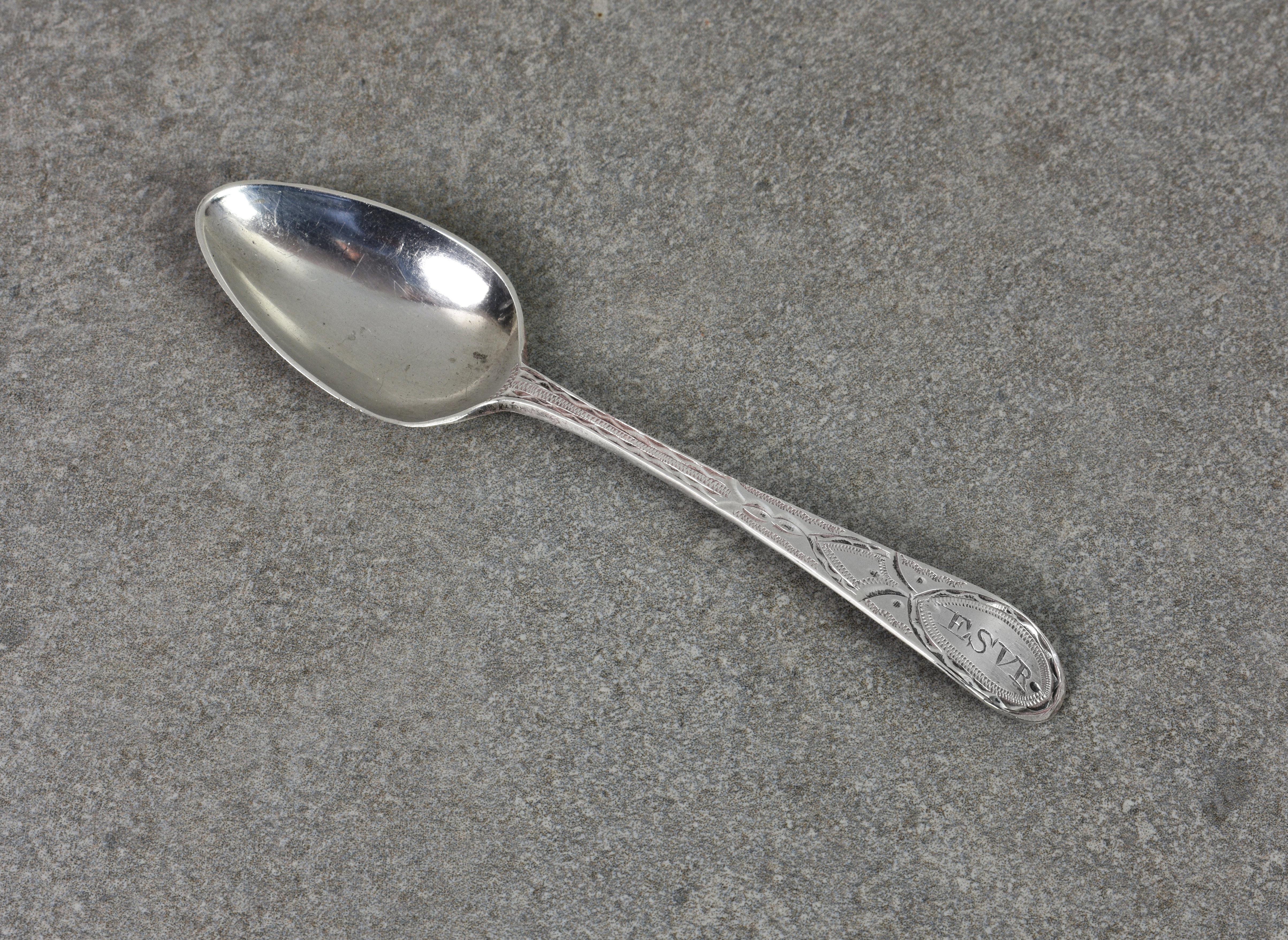 A Channel Islands silver bright cut Old English pattern teaspoon, maker's mark IP, struck once (