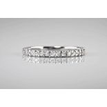 An 18ct white gold and diamond half eternity band, with pavé diamonds totalling approximately 0.