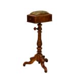 A Victorian walnut adjustable sewing table with pin cushion top, over a single drawer, on a a turned