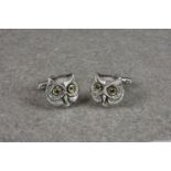 A novelty pair of silver cufflinks fashioned as owls, stamped sterling silver, each with yellow