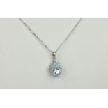 An 18ct white gold, aquamarine and diamond cluster pendant, the pear cut aquamarine within a