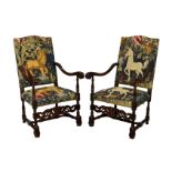 A pair of Carolean style carved and stained beech armchairs, 20th century, the serpentine backs