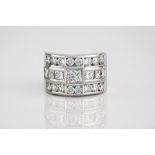 A fine 18ct white gold and diamond ring, set with three rows of princess and brilliant cut diamonds,