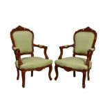 A pair of French style carved beech wood fauteuils, in the Louis XV style, late 20th century, the