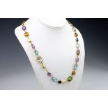 An 18ct varigem necklace, featuring mixed cut amethysts, smoky quartz, peridot, blue topaz,