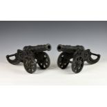 A pair of heavy cast metal fireside cannons, black painted of Spanish 17th century style, each