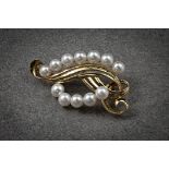 A Mikimoto 14ct gold and cultured pearl brooch, of openwork, scrolling foliate form, set with twelve