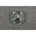 A novelty silver brooch pendant fashioned as horse and shoe, with emerald style cabochons, stamped