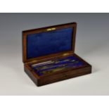 An antique cased technical drawing set, the hinged lid opening to reveal a pull-out tray with fitted