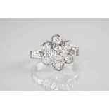 An 18ct white gold and brilliant cut diamond cluster ring, featuring 7 brilliant cut diamonds held