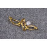 A 9ct yellow gold, cultured pearl and diamond brooch, the brooch consisting of yellow gold swirls,
