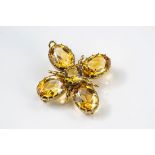 A vintage 9ct gold and citrine pendant brooch, 1960s, set with four oval cut citrines and a