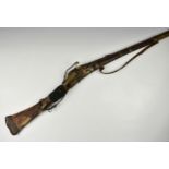 A 17th century Arabian matchlock musket, Abu Fatilah, part ribbed barrel with waisted flared end,