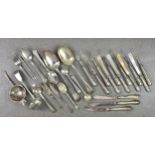 A collection of various silver cutlery and smalls, including a tea strainer with art deco style
