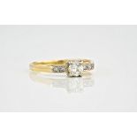 An 18ct yellow gold diamond ring, the central, brilliant cut diamond measuring approximately 0.36ct,