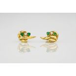 A pair of 18ct yellow gold, emerald and diamond studs, of free flowing form and featuring two