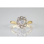 An 18ct yellow gold, platinum and diamond cluster ring, the central old brilliant cut diamond