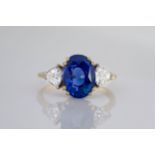 An important 18ct white gold, Burmese sapphire and diamond ring, the central, oval cut sapphire of