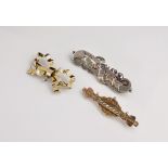 Three Victorian gold and silver brooches, comprising a 9ct gold bow brooch with fob attachment; a