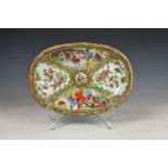 A Chinese Canton famille rose oval dish, early 19th century, enamelled in the typical palette with