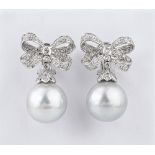 A good pair of 18ct white gold, South Sea pearl and diamond drop earrings, the 15mm. pearls on