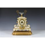 A 19th century French alabaster cased mantel clock, surmounted by a squat lidless urn with gilt