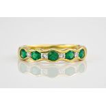 An 18ct yellow gold, emerald and diamond ring., Featuring 5 emeralds interspersed by 4 diamonds,