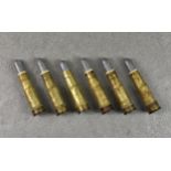 Six .577 Martini-Henry lack powder centrefire rifle cartridges, each stamped with letters K & I with