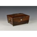 An early 19th century rosewood work box, of sarcophagus form, having mother of pearl escutcheon and