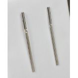 A pair of 9ct white gold knife-blade drop earrings, 46mm. drop. (2)