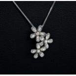 A 9ct white gold and diamond flower pendant necklace, the pendant designed as 3 interlinking