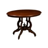 A late Victorian oval walnut centre table, the moulded top raised on four shaped supports issuing
