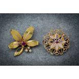 A French 18ct yellow gold, seed pearl and ruby floral brooch, early 20th century, 27mm. long;