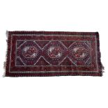 An Ersari rug, worked in pale aubergine, dark red, orange, dark brown and ivory, with three