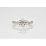 A palladium and diamond cluster ring, consisting of 7 round cut diamonds in claw settings. Ring size