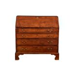 A George III mahogany bureau, the cross banded fall enclosing a fitted interior with central