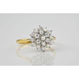 An 18ct yellow gold and diamond cluster ring, the three-tier cluster of nineteen brilliant cut