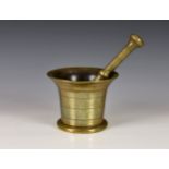 A 18th century polished bronze pestle & mortar, of typical bell form, having flared rim above