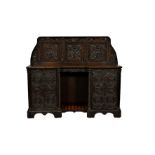 A Victorian carved oak side cabinet, made using some earlier elements, the shaped three panel back