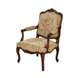 A Louis XV style carved beech wood fauteuil, late 20th century, the padded, squared cartouche back