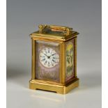 A brass cased miniature carriage clock with porcelain panels, of typical form in miniature, with