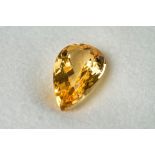 A loose precious yellow topaz, of rich, golden colouring.