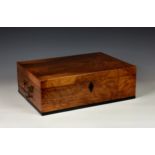 A Victorian walnut stationery box, with twin brass carrying handles, the hinged lid opening to
