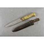 A WWI trench knife and leather scabbard, shortened from a bayonet, brass and copper ribbed handle,
